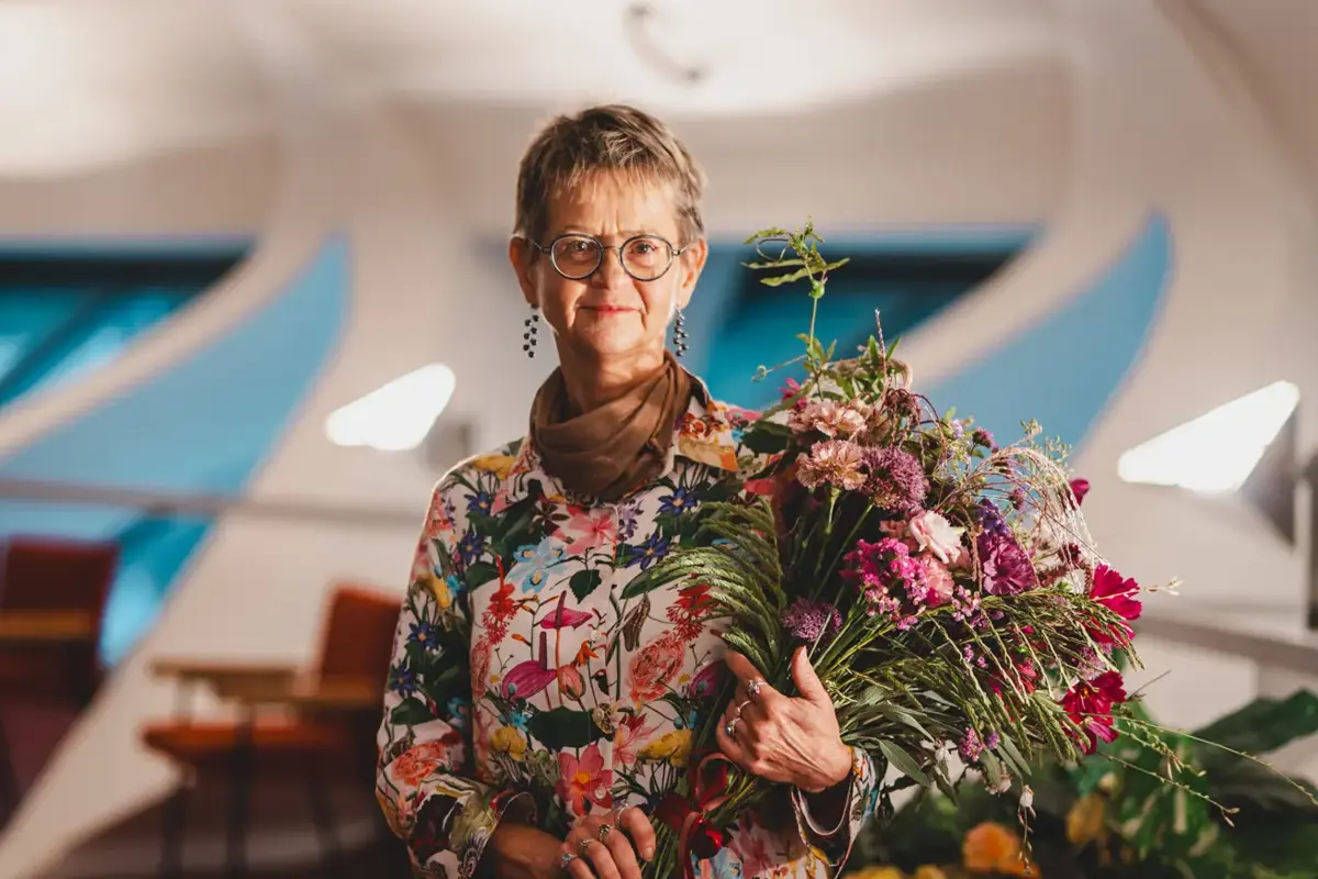 Porträttfoto Maria Kylin med stor blomsterbukett.